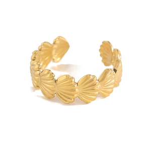 Detail shot of golden shell-shaped links on a nautical summer open ring design