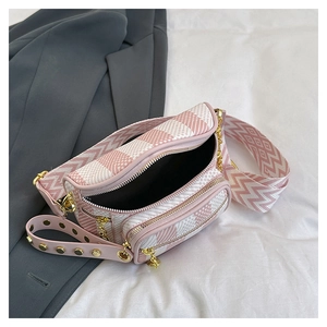 Detailed view of pink plaid chest bag with wide geometric strap and gold-tone zippers