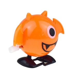 Detail of orange clockwork monster toy with single eye and mechanical winding knob