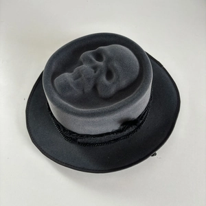 Top macro view of 3D skull relief on a black felt flat top gothic cowboy hat