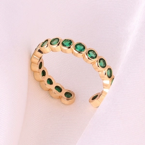 Minimalist 18k gold plated copper ring with green zircon stones on pink silk