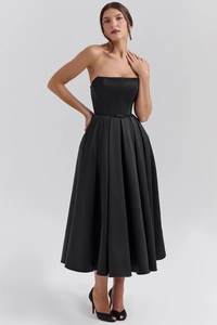 Detail of elegant black strapless midi dress featuring satin finish and pleated skirt