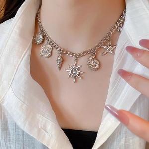 Silver chunky chain necklace with shell and starfish charms on a white shirt model