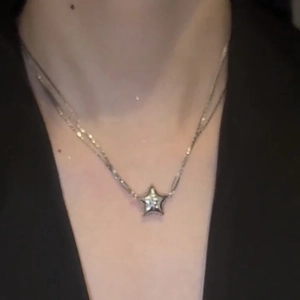 Sparkling magnetic star pendant necklace in stainless steel on a model's neckline