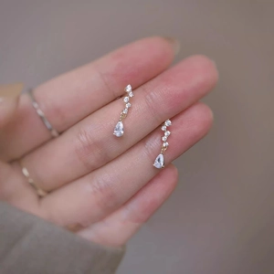 Exquisite gold teardrop earrings with sparkling cubic zirconia stones for an elegant look