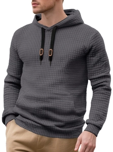Close-up of dark grey waffle knit fabric texture on a men's drawstring hoodie