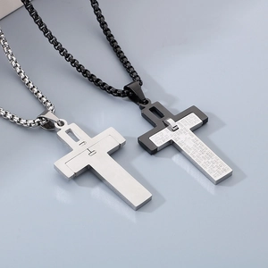 Detailed close-up of dual-tone cross pendants with engraved English scripture and box chain
