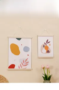 Detail of minimalist wooden magnetic poster hanger with abstract botanical art print