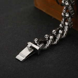 Close-up of punk style titanium steel skull link bracelet with sturdy clasp