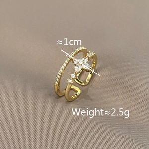 Detail shot of golden double-layer star ring with rhinestones on beige fabric background