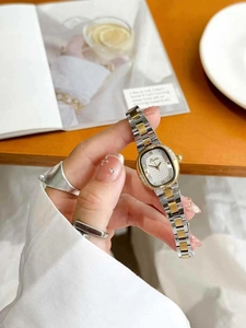 Close-up of square women's watch with diamond bezel and bicolor steel bracelet