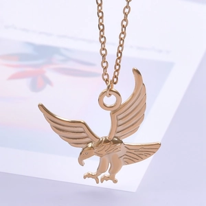 Detailed view of a golden eagle pendant with spread wings on a stainless steel necklace