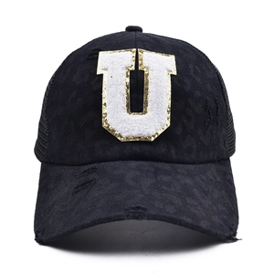 Detail of distressed cotton baseball cap with sequined U patch and breathable mesh