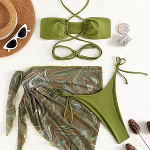 Three-piece bikini set with moss green wrap skirt and vintage fluid print pattern