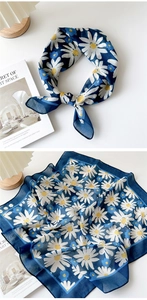 Detailed view of dark blue cotton linen scarf with white daisy print and soft texture