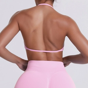 Detailed back view of seamless pink halter sports bra and high waist yoga leggings