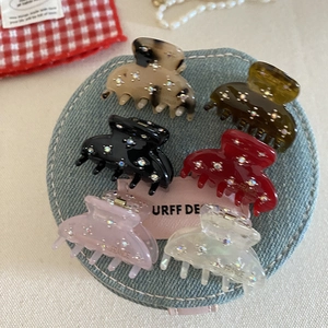 Set of 6 mini rhinestone acetate claw clips in various colors on denim display