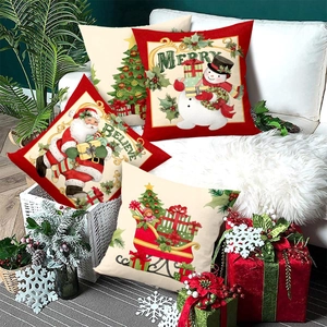 Set of 4 Christmas pillow covers with Santa and reindeer prints on a sofa