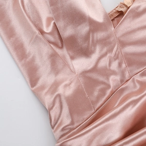 Close-up of pink satin halter neckline showing high-quality stitching and size L label