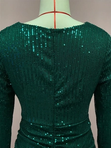 Detail view of dark green sequin dress back with long sleeves and hidden zipper