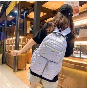 Rear view of a model wearing the lavender backpack with cute white bear patterns