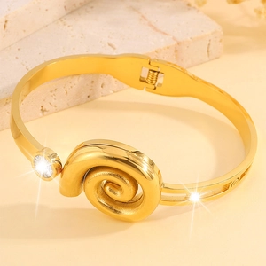 Elegant gold-plated stainless steel bangle featuring a spiral cubic zirconia centerpiece