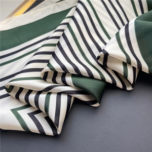 Detail view showing the silky texture and green striped pattern of this square scarf