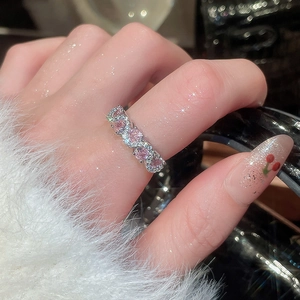 Close-up of sparkling pink heart-shaped zircon ring with silver-plated micro-pave setting