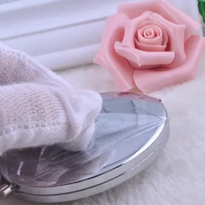 Polished silver metal round folding makeup mirror with clear protective film on back