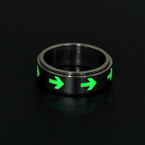 Glow-in-the-dark arrow rotatable stainless steel ring with luminous green patterns on black metal