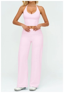 Detail of pink yoga set with halter top and high-waisted wide-leg athletic pants