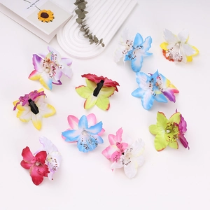 Close-up of tropical orchid hair clips with realistic petal texture and center pearls