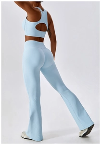 Detail view of light blue ribbed sports bra and yoga pants with cross back design