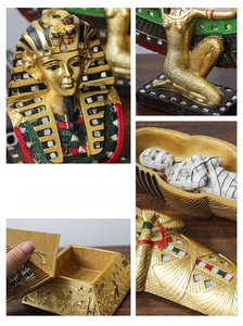 Detailed relief carvings and sequins on Egyptian pharaoh figurines and resin craft box