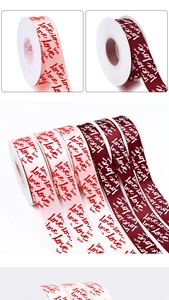 Close-up of pink and burgundy satin ribbons with love script for gift decoration