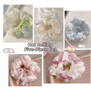 Detail view of five-piece cream-style ballet ribbon scrunchie set in organza fabric