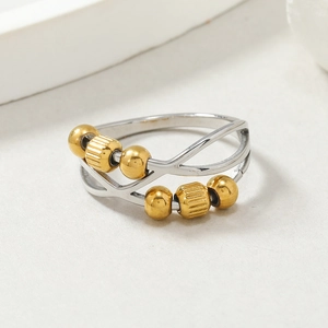 Minimalist spinning anxiety ring with golden beads on stainless steel band