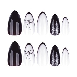 Y2K almond press-on nails featuring black French tips, bows, and silver glitter accents