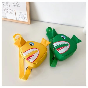 Detail of yellow and green shark-themed nylon chest bags with adjustable straps for kids