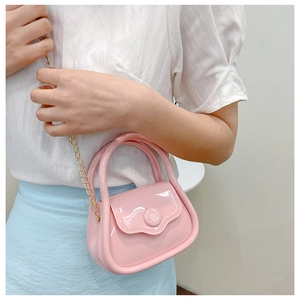 Pink jelly mini handbag with gold chain strap shown on model for size perspective