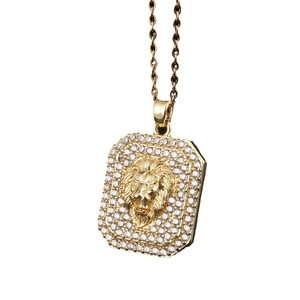 Gold lion head rectangular pendant necklace with gemstone inlay on white background