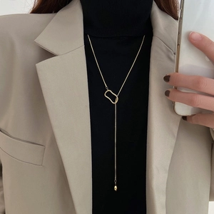Minimalist gold Y-shaped long sweater chain with adjustable geometric ring pendant