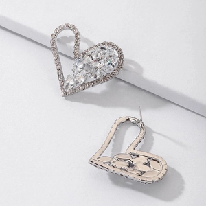 Macro shot of silver heart earrings with marquise-cut cubic zirconia and micro-pavé crystals