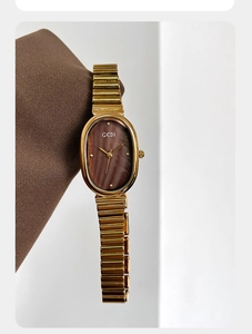 Detail of GEDI oval gold watch with brown marble dial and stainless steel mesh band