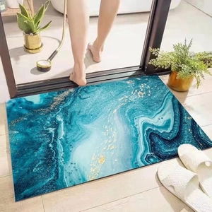 Absorbent diatom mud bath mat with blue and gold marble pattern at the bathroom door