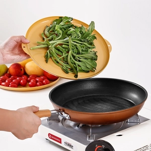 Copper non-stick frying pan set with wood grain handle and matching food plate