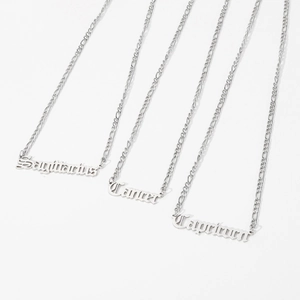 Detail view of silver Figaro chains with Sagittarius Cancer and Capricorn pendants