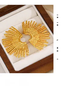 Macro shot of 18K gold plated fan-shaped earrings with textured molten metal finish