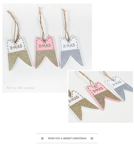 Close-up of wooden X-MAS banner pendants with gold glitter and hemp rope hangers