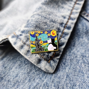 Artistic Van Gogh Starry Night enamel pin featuring black and white cats on denim jacket